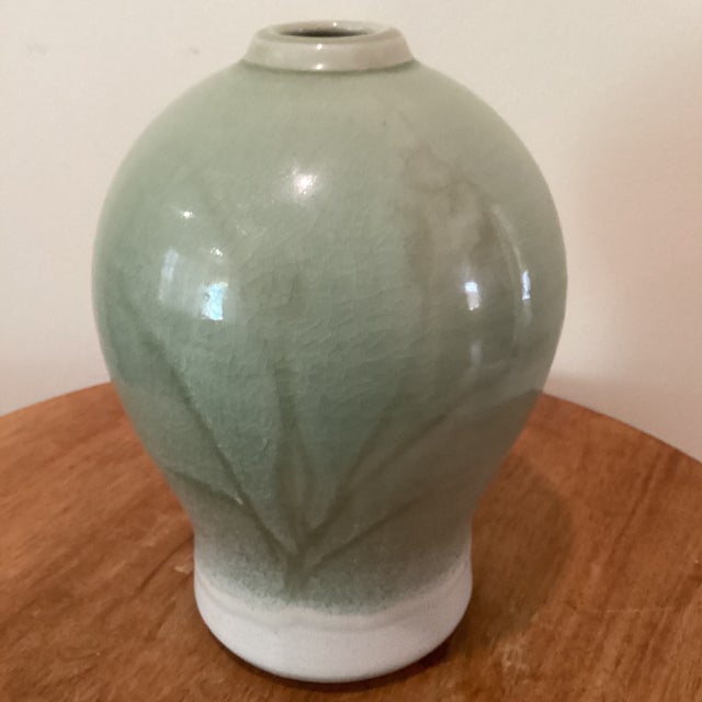 The Vintage Green Celadon Glazed Bamboo Design Porcelain Vase by Richey Bellinger (circa 1982) is a highly collectible...