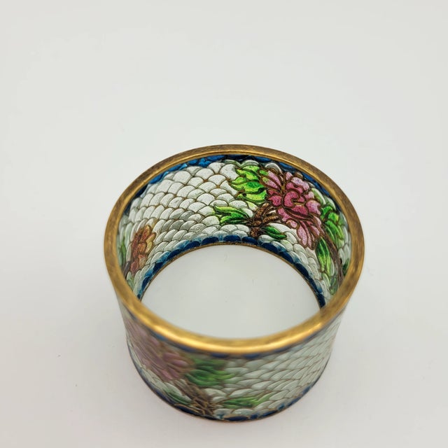 Beautiful and delicate. The colors are still vibrant. The original box is lined with satin and holds the rings securely....