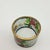 Beautiful and delicate. The colors are still vibrant. The original box is lined with satin and holds the rings securely....