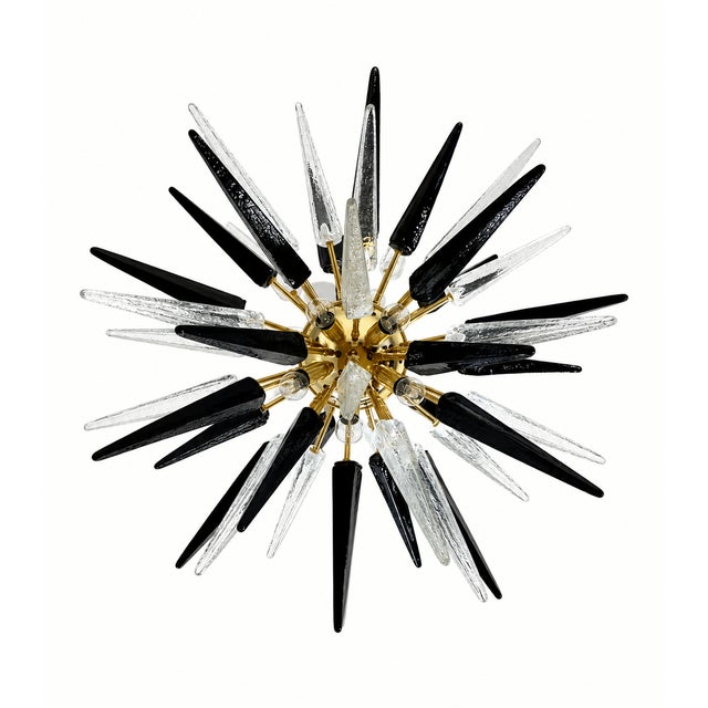 Italian Sputnik chandelier with 51 blown Murano glass tips, alternating in transparent and black hues. The brass-plated...