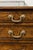 An English George III period burl wood chest-of-drawers from the early 19th century, with feather banding inlay and bronze...