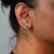 Set in solid 14K white gold, these earrings pair two emerald-cut colombian emerald stones of 0.42 carats with thirty-two...