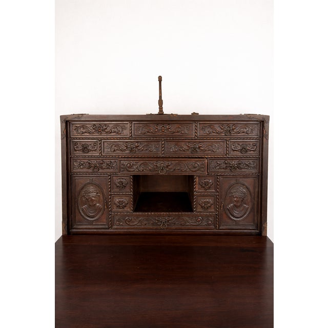 Striking antique European cabinet crafted in solid oak with hand-forged iron hardware, showcasing rich Old World...