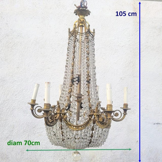 A very beautiful chandelier in the shape of a "hot air balloon" or "beaded bag," made of bronze with crystal beads. It...