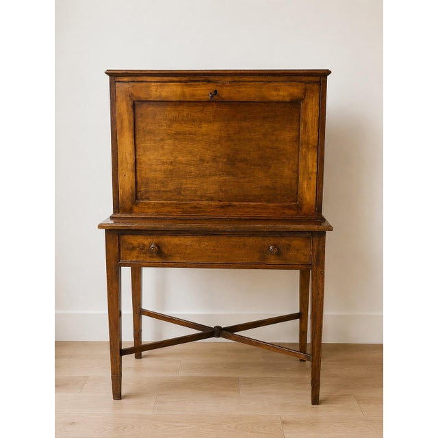 A handsome 19th-century writing desk featuring warm, richly figured wood and an elegant, restrained silhouette. The upper...