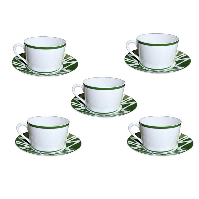A striking set of five matching cup-and-saucer pairs in Bill Goldsmith’s New Florida Green pattern for Porcelaine du Site...