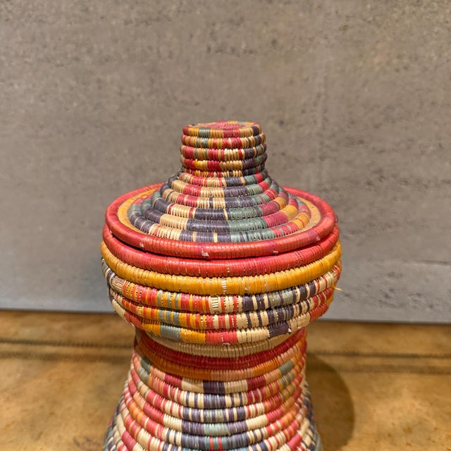 For your consideration, a traditional Ethiopian Mesob basket, a handwoven container crafted from dyed grass and palm...