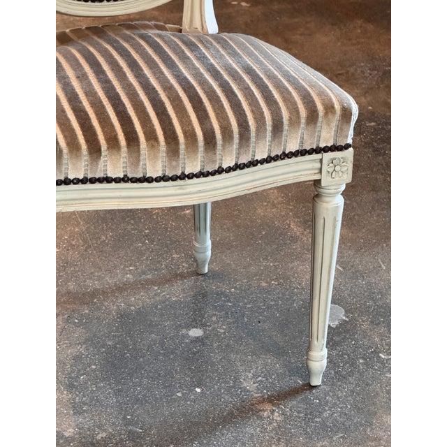 Set of six Louis XVI style dining chairs, each with an oval medallion back above a shaped seat, the frames painted in pale...