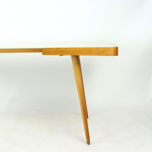 Elegant mid-century coffee table produced by Interiér Praha in Czechoslovakia during the 1960s. The original...