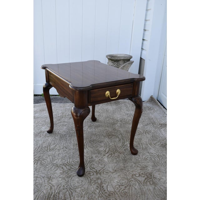 Vintage (1990's) Side/End Table has a Queen Anne Style. The Wood is Cherrywood. The Finish is Brown with One Drawer with...