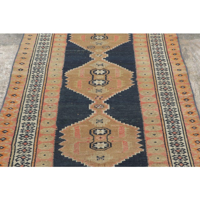 Handwoven in wool, circa 1910–1920, this antique 4x6 Kurdish rug features bold geometric medallions across a dramatic...
