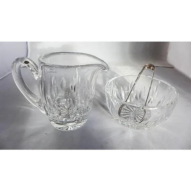 Three-Piece crystal creamer and sugar with silverplate sugar tongs. Maker's mark reads "Waterford, Holmes & Edwards...