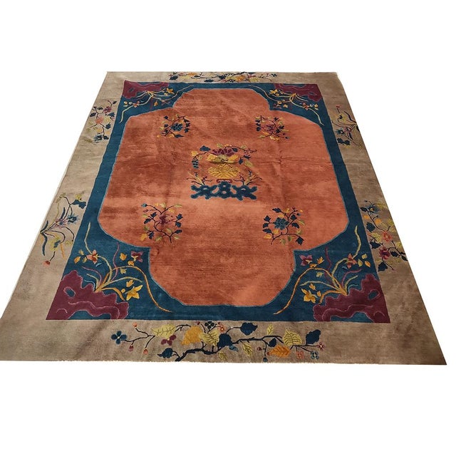 Floral Medallion Rectangle Hand Knotted Pile 1920s Antique Wool Coral Rug, Circa Date: 1920s. This exceptional piece from...