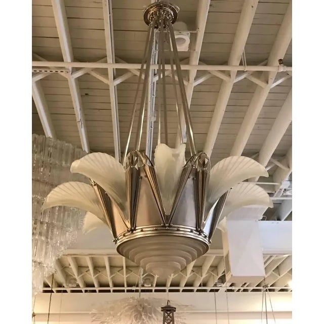 Important and grand French Art Deco chandelier signed by famous artist G Leleu. Having a clear frosted molded glass center...