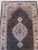 This brown earth tone wool rug features a hand knotted pile weave typical of classic Agra rugs. It is a genuine hand...