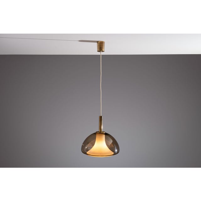 This exquisite hanging lamp combines Italian Murano glass craftsmanship with timeless mid-century elegance. The outer...