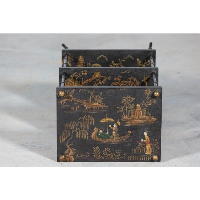 Circa 1950 Mid-Century ‘Harrods’ Chinoiserie 3 Tier Etagere. Black and gilt Chinoiserie decorated with three tiers and...