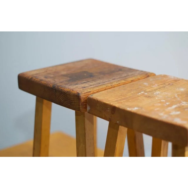 Lot of 3 Charlotte Perriand Pine wooden stools for 1800 Arcs. Square sitting. Four feet. Provenance: Residence The needle...