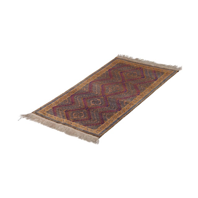 Hand knotted in wool originating between 1950-1960, this vintage Persian rug enjoys both an astutely preserved quality...
