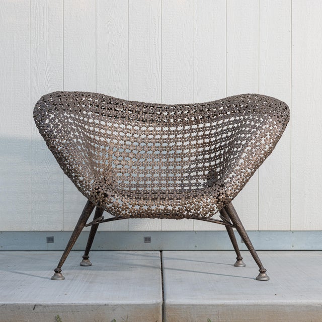 An exceptional sculptural lounge chair attributed to French artist and metalworker Raymond Moralès (1926–2004), featuring...