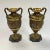 Pair of antique patinated bronze vases with variegated green marble pedestals in the Roman neoclassical style featuring...