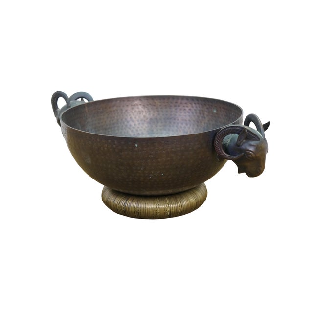 Large and impressive vintage hammered brass centerpiece bowl / jardiniere / cachepot featuring rams or goats heads with a...