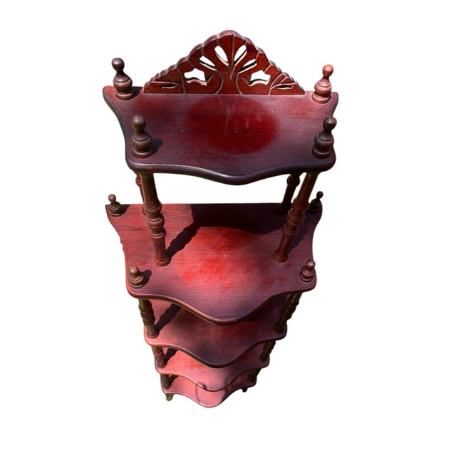 A lovely cherry wood 5-tiered reproduction Regency style etegere with carved cornace and sculpted wood frame. Dating from...