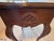 Vintage French Provincial accent table, solid wood with a warm mahogany-tone finish. Serpentine scalloped top, graceful...