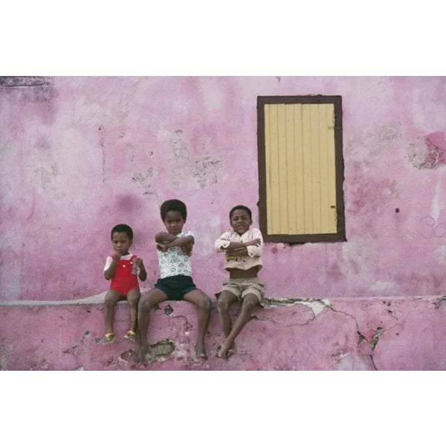 Curacao Children 1979 by Slim Aarons Slim Aarons Limited Estate Edition Three local children sitting on a low wall,...