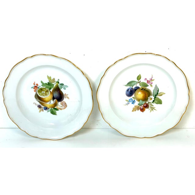 Pair of 19th-Century Meissen Hand-Painted Fruit Cabinet Plates with Gilt Scalloped Rims A refined pair of 19th-century...