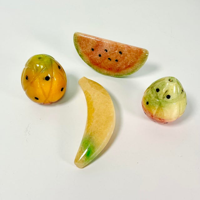 This is a lovely set of 4 hand-carved Marble pieces of Fruit. The set includes two small pineapple, a banana and a slice...