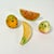 This is a lovely set of 4 hand-carved Marble pieces of Fruit. The set includes two small pineapple, a banana and a slice...