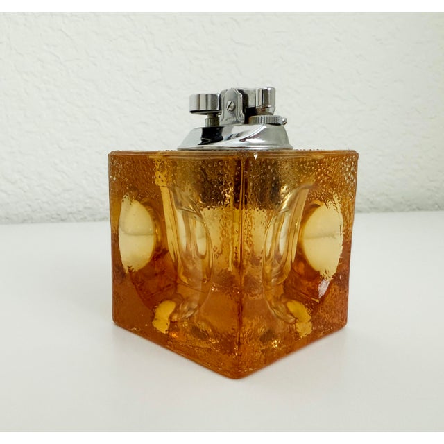 A set of heavy amber glass Murano-style table lighter and ashtray in the style of Antonio Imperatore's glasswork, produced...