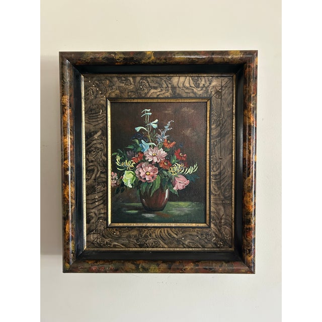 Vintage oil painting of a floral still life in hand painted Victorian frame. Signed to the lower right corner and...