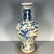 A striking Chinese blue and white porcelain vase featuring a heavy, all-over crackle glaze. The vase has a baluster shape...