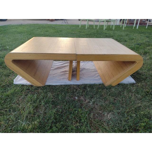 This is a set of 2 post modern pencil reed wood waterfall style end or side tables. These tables are in good condition...