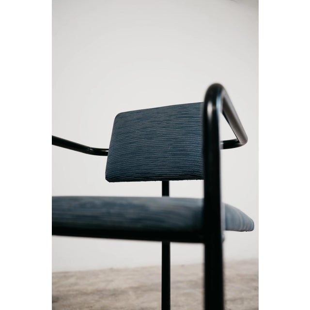 A stunning and exclusive minimalist vintage armchair dating back to the 1980s, a true piece of modern design with an...