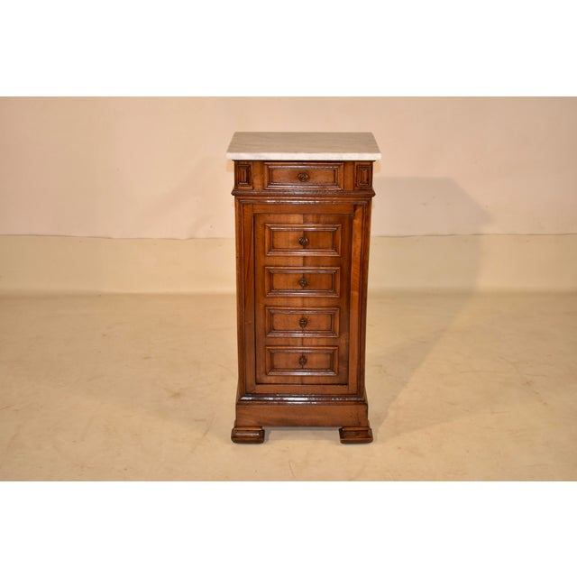 19th century Louis Philippe bedside cabinet from France. The top is made from Carrara marble and rests upon a walnut case....