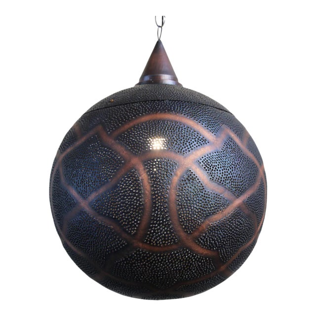Antiqued copper globe lantern with perforated moorish design patterns that shine beautiful patterns onto walls and...