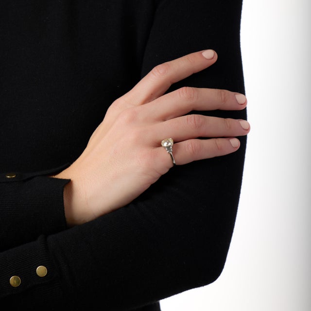 This extraordinary Mid Century engagement ring is a powerful expression of timeless design and refined elegance, anchored...