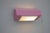 A vintage bedside sconce or wall lamp, in a very pink color in an angular brutalist blocky design from the 1970s. Made by...