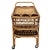 A unique 1930s rattan bar cart features a Pole Rattan rattan frame with woven wicker tops and stick rattan bottle holders....
