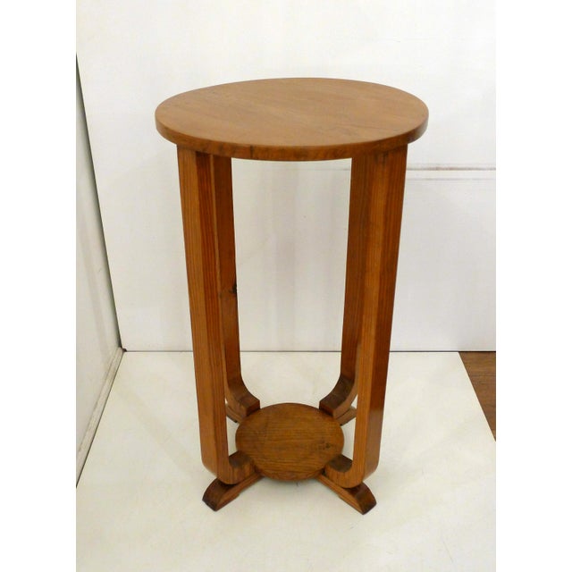 Small Art Deco side table/pedestal with two levels (lower shelf with spacer), round tops, and four square-profiled legs...