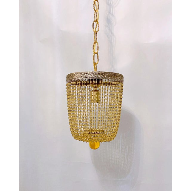 Italian Basket chandelier with bronze rim and amber cut beads chains .It has 1 Edison base socket and hold up to 75 watts...