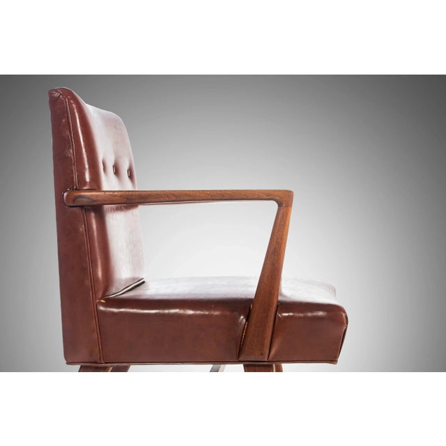 A rare and elegant 1950's walnut armchair, Model 108, designed by Jens Risom for Risom Designs Inc. This collectable chair...