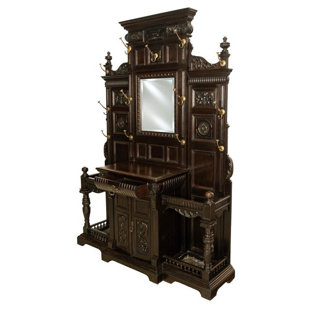 A fine and monumental antique Renaissance Revival carved oak hall tree / stand, circa 1880. This very regal antique hall...