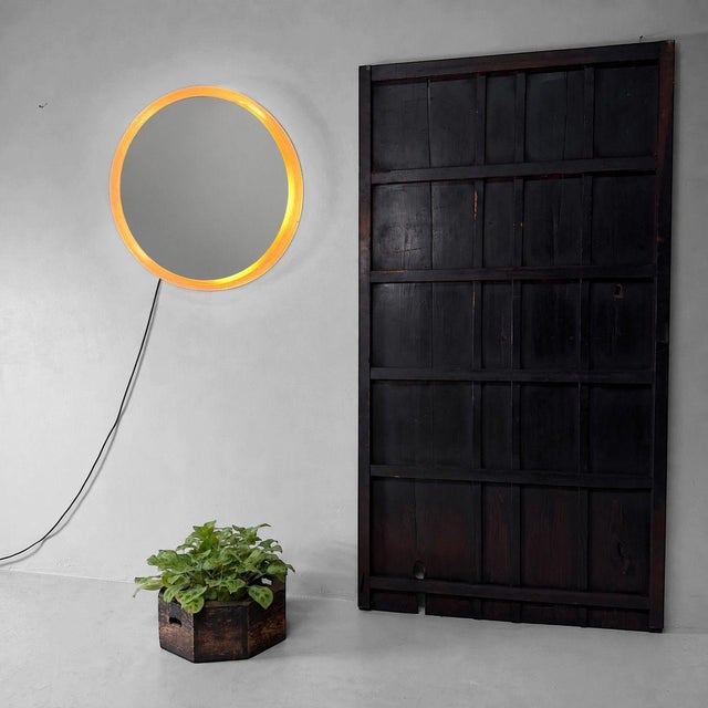 Distinctive round wall mirror by Hillebrand from the 1970s, featuring a characteristic acrylic frame and integrated...
