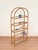 Stunning and one-of-a-kind large arched bookcase in rattan and brass with crystal shelves. This exceptionally elegant...