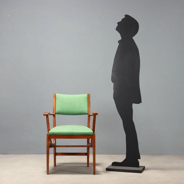 1950s Italian armchair with wooden frame, seat and backrest upholstered in green fabric. Ideal for those seeking...