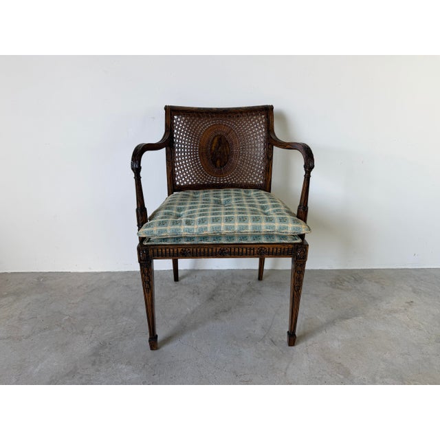 Elegant vintage Hollywood Regency style armchair featuring a beautifully faux grain-painted wood frame with a rich ebony...